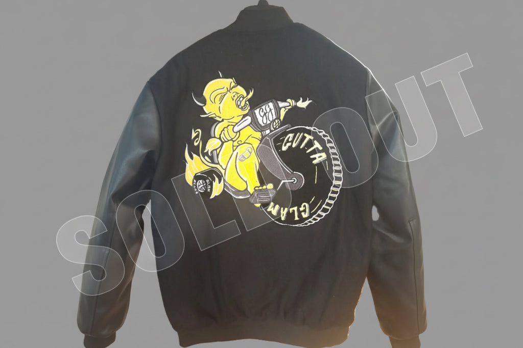 Black jacket with a graphic design of a yellow character on a motorcycle and text on the back.